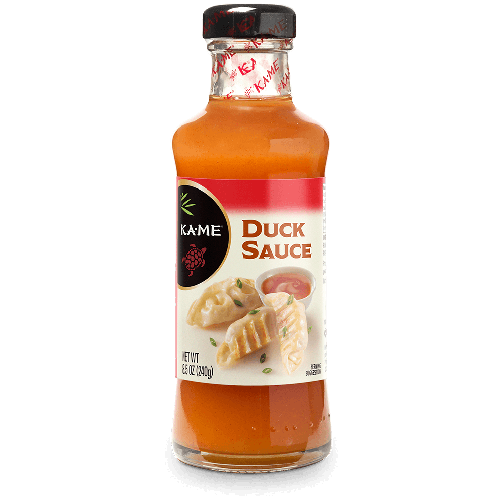 A 12 fl oz glass bottle of Kame Duck Sauce, showing the orange-brown sauce inside, a black cap, and a white label with red and black accents.