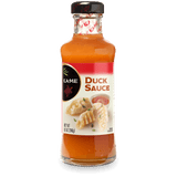 A 12 fl oz glass bottle of Kame Duck Sauce, showing the orange-brown sauce inside, a black cap, and a white label with red and black accents.