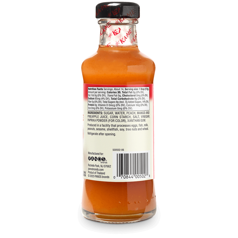 Back view of a small glass bottle of Kame's Sauce with orange-red sauce inside, a black cap, and a white product information label.
