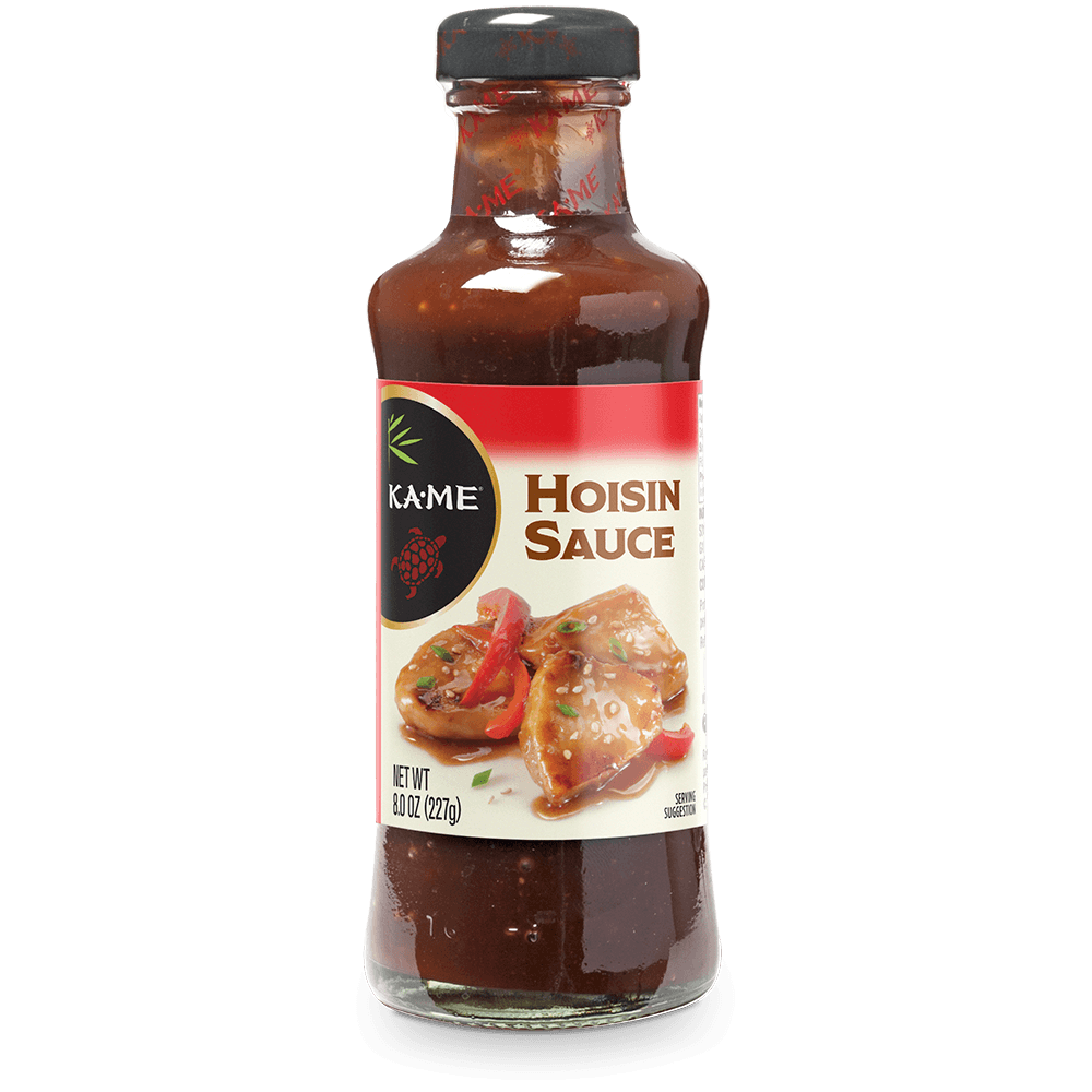 A bottle of Kame Hoisin Sauce on a plain white background. The glass bottle shows the dark reddish-brown sauce inside, with a white and red label featuring an image of grilled chicken and red peppers, and a black cap.