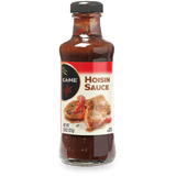 A bottle of Kame Hoisin Sauce on a plain white background. The glass bottle shows the dark reddish-brown sauce inside, with a white and red label featuring an image of grilled chicken and red peppers, and a black cap.