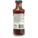 A bottle of sauce shown from the back, displaying the nutrition facts label, ingredients list, manufacturer details, and barcode against a white background.