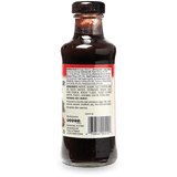 Back view of a bottle of Bold's Creamy Garlic Parmesan Sauce, showing the label, barcode, and ingredients list on a white background.