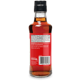 The back of a glass bottle of Anchovies Corded Fish (Anchovies) showing the red label, barcode, and nutritional information, topped with a black cap, on a white background.
