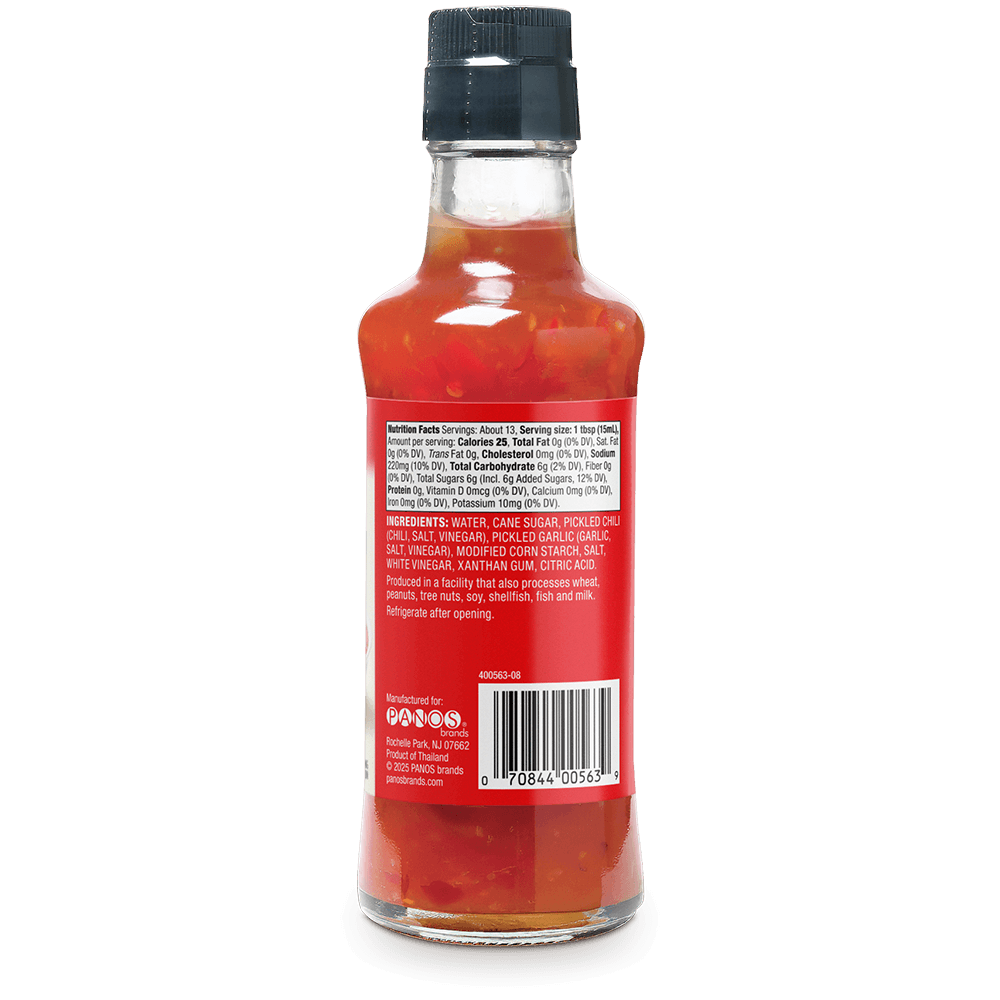 Back view of a hot sauce bottle showing the ingredients label, with red sauce visible through the clear glass and a black cap, on a white background.