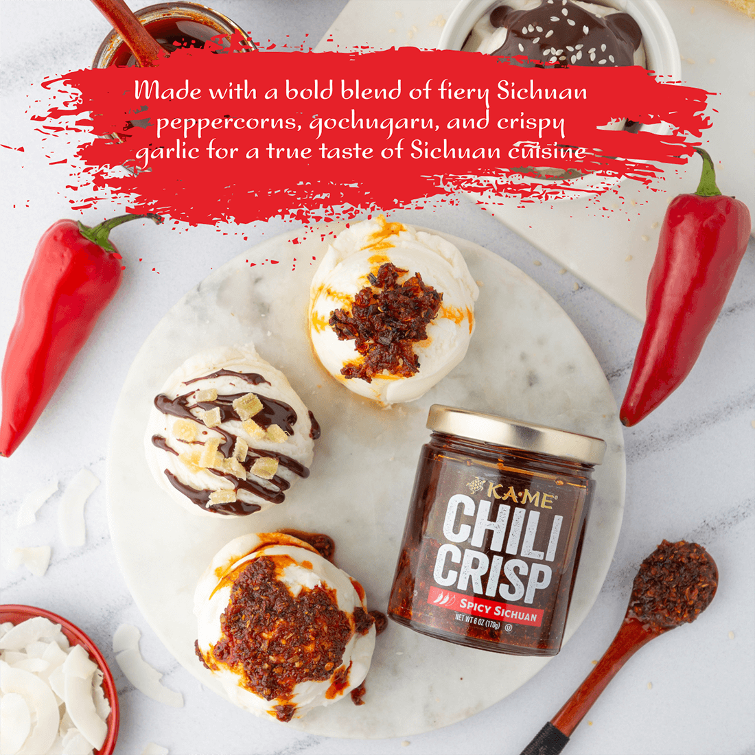 Kame Chili Crisp jar with decorative items on a white surface, featuring text about Sichuan peppercorns and garlic.