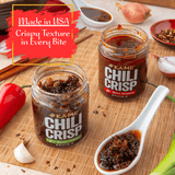 Two jars of KAME Chili Crisp on a wooden surface with ingredients and text about crispy texture.